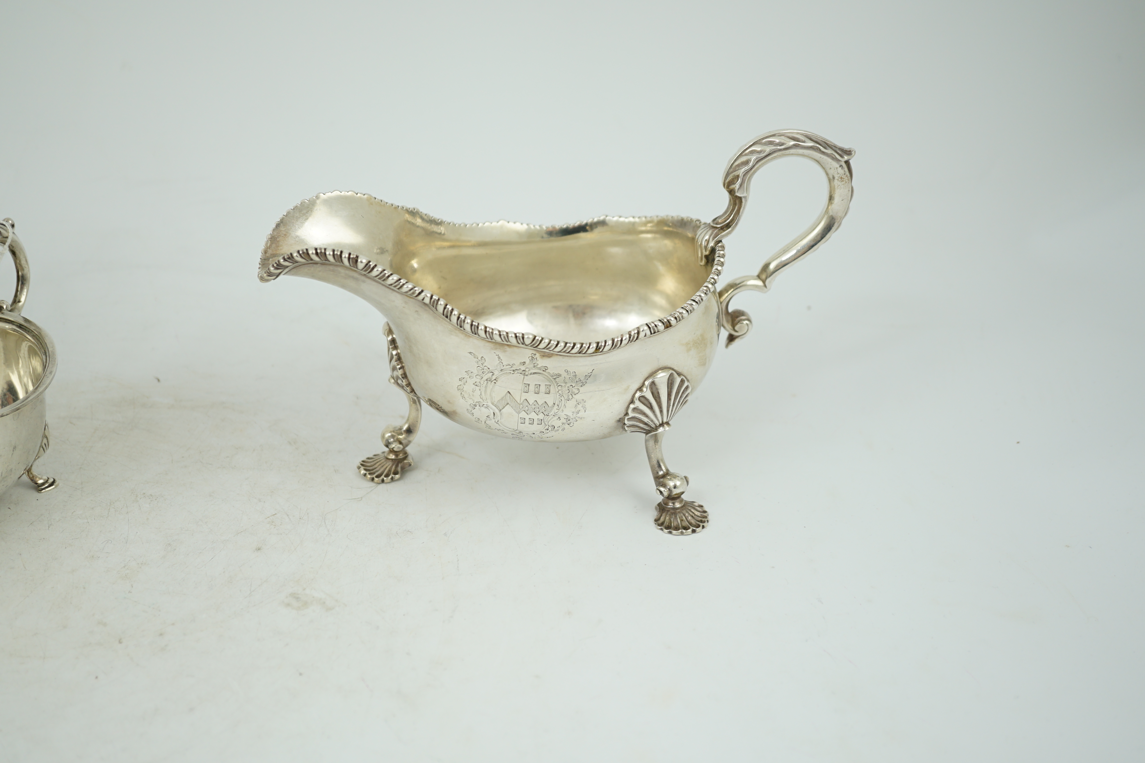 A George III silver sauce boat, with gadrooned border and shell knees, on fluted feet, Francis Crump, London, 1770, length 20.8cm, 13.9oz.